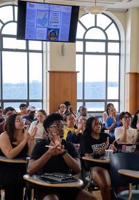 Students in a classroom applaud